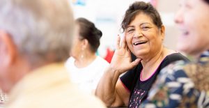 Smiling Hispanic Woman in a Senior Activity Center